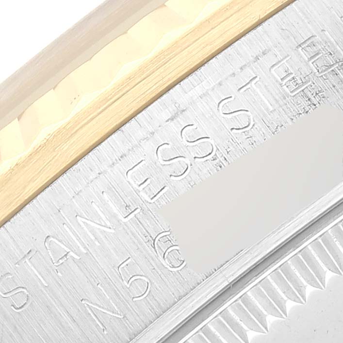 This image shows a close-up of the stainless steel and gold bezel of a Mid-Size Rolex watch.