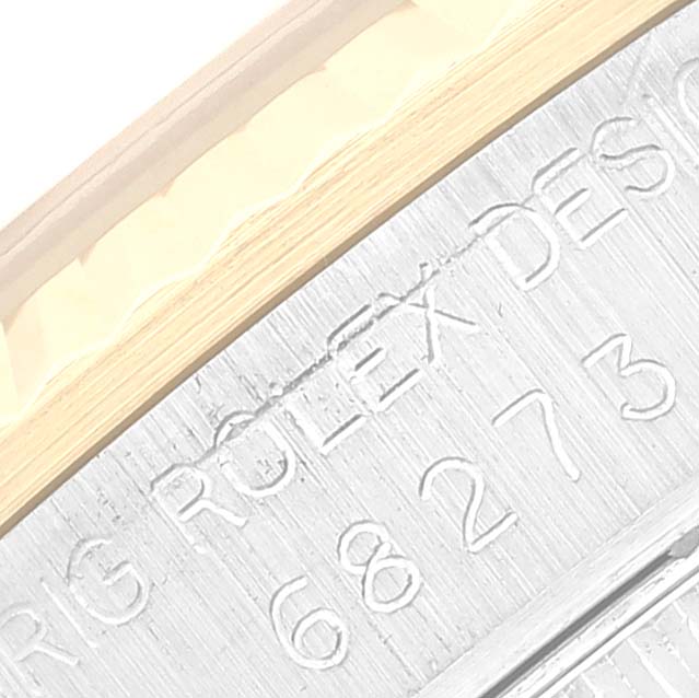 This close-up image features engravings on the side of a Mid-Size Rolex watch.