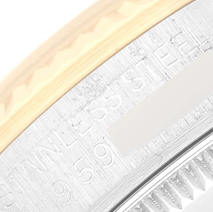 This close-up image shows the side view of the bezel and fluted edge of a Mid-Size Rolex watch.