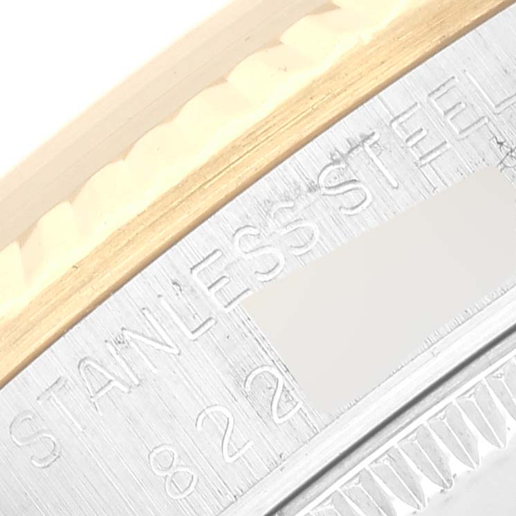 This image shows a close-up of the bezel and case-back edge of a Mid-Size Rolex watch, highlighting the "Stainless Steel" engraving.