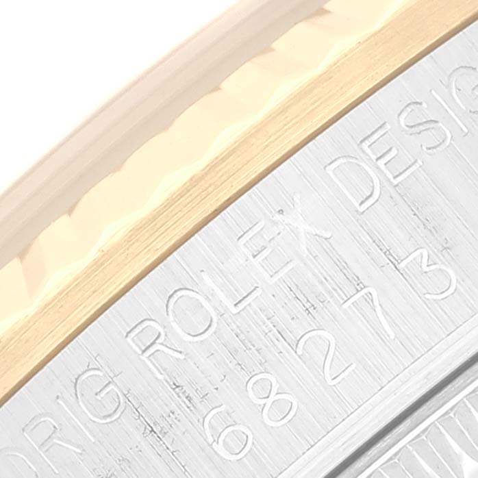 This close-up angle shows the engraved side of the case of the Rolex Mid-Size 68273 Women
s Steel and Gold (two tone) Champagne Dial 68273 Women
s Steel and Gold (two tone) Champagne Dial watch, featuring the model details.