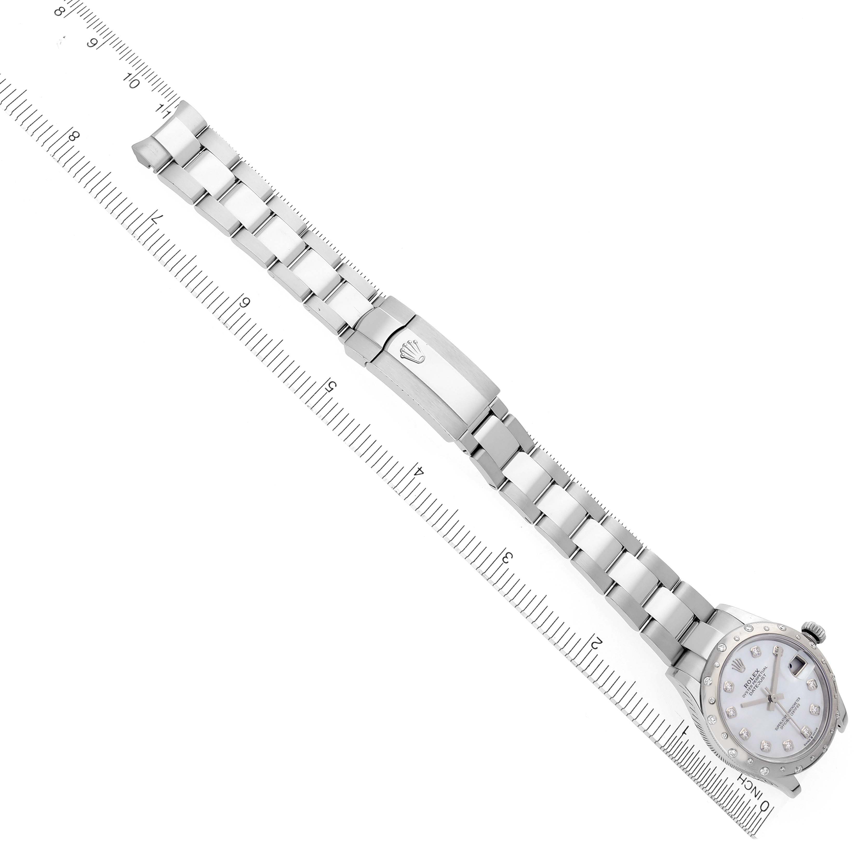 The Rolex Mid-Size 278344RBR Women's Stainless Steel Mother of Pearl Dial 278344RBR Women's Stainless Steel Mother of Pearl Dial watch is displayed flat, showing the bracelet and clasp alongside a ruler for scale.