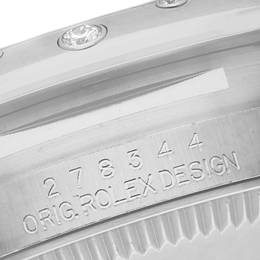 The image shows a close-up of the bezel and inner engraving of a mid-size Rolex watch.