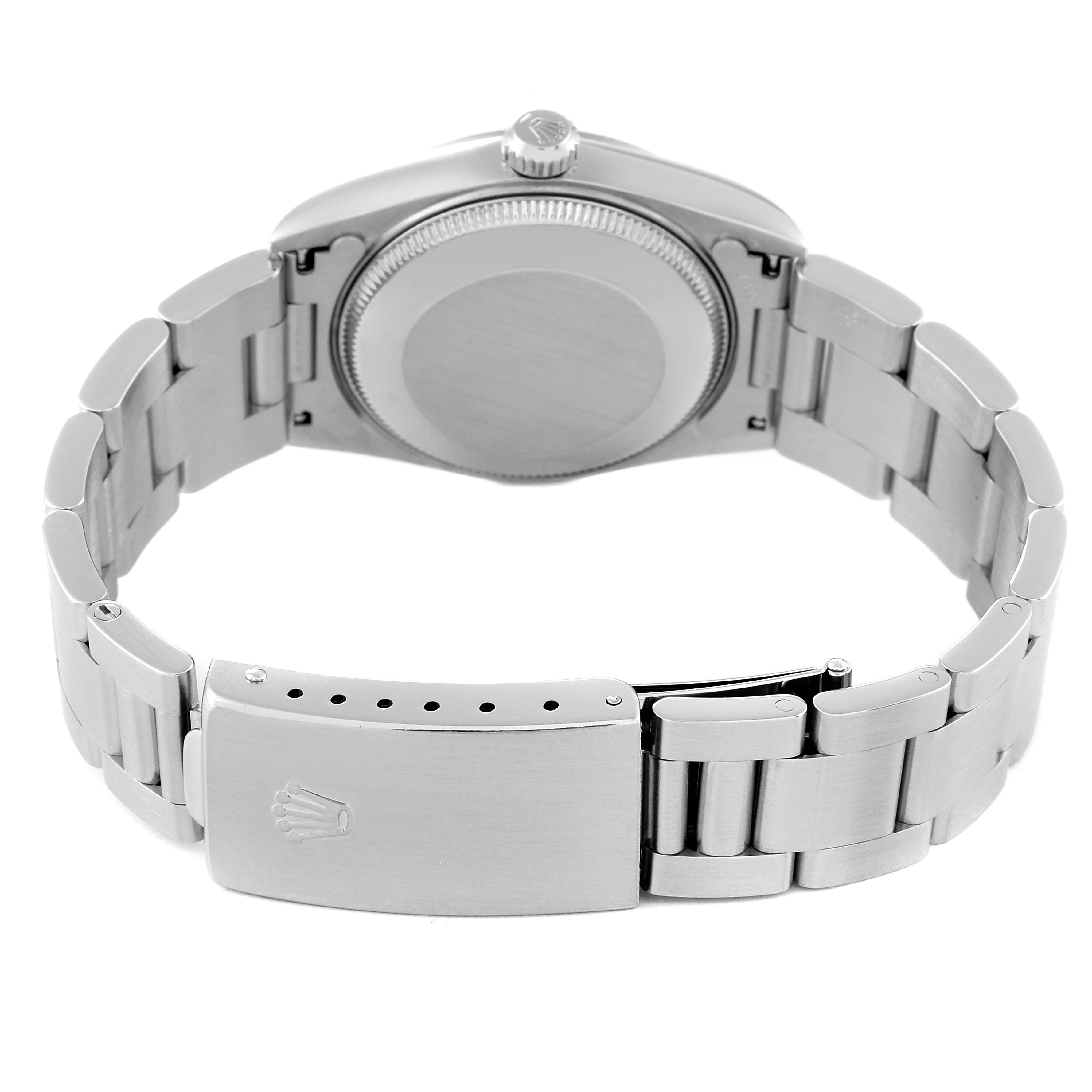 The image shows the back view of a mid-size Rolex watch, focusing on the case back, bracelet, and clasp.