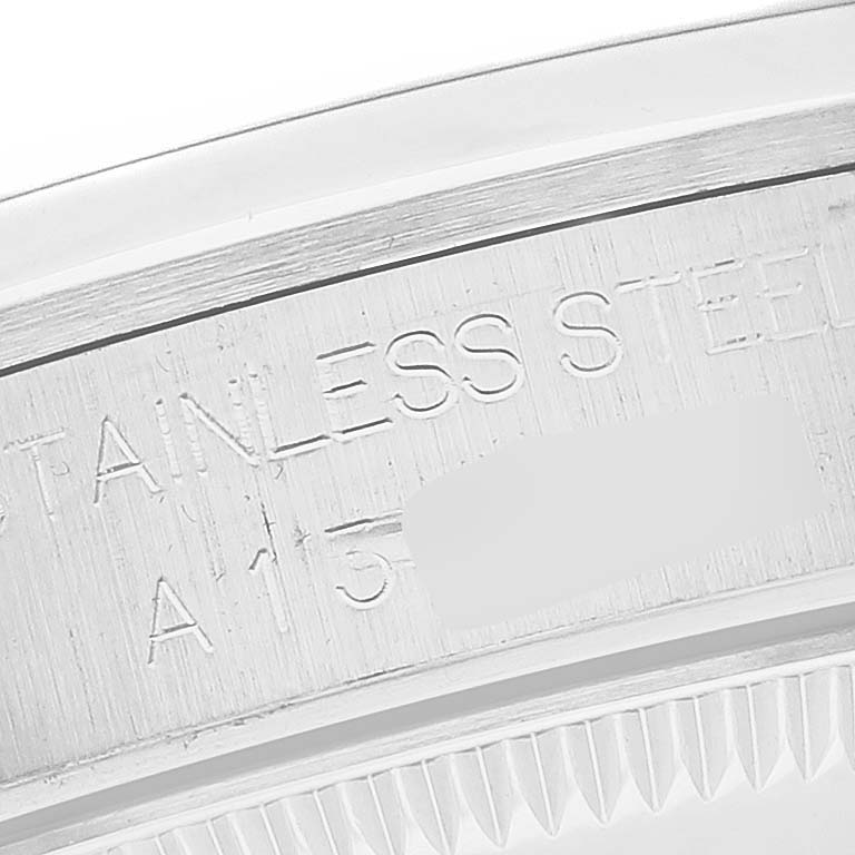 The image shows a close-up of the stainless steel case and serial number engraving of a Mid-Size Rolex watch.