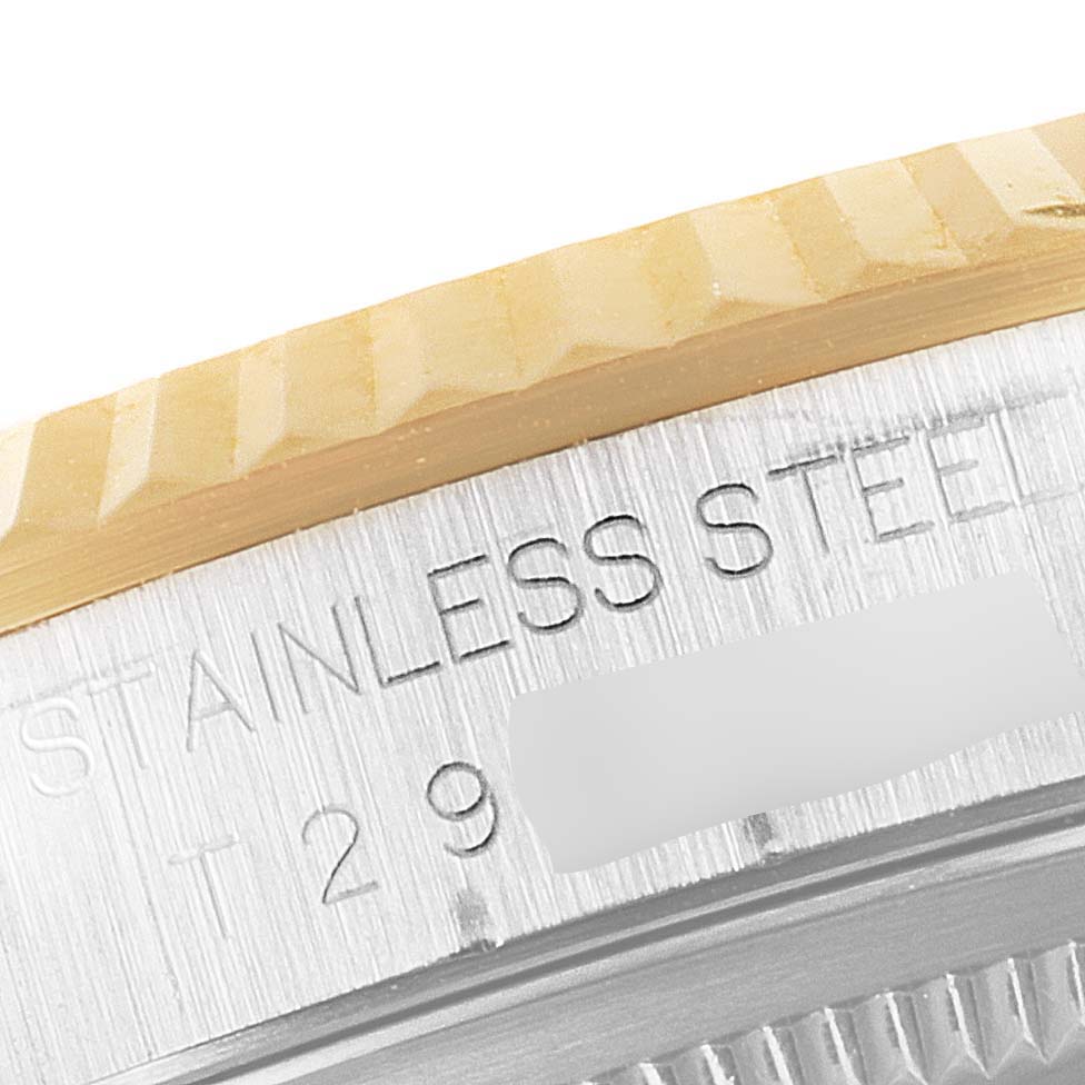 This close-up image features the side of the bezel and the engraved stainless steel casing of a Rolex Datejust 16233 Men's Steel and Gold (two tone) Black Dial 16233 Men's Steel and Gold (two tone) Black Dial watch.