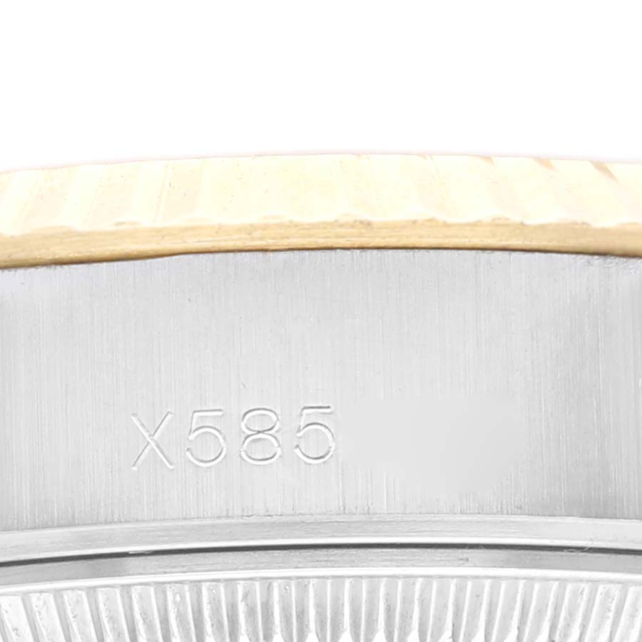 This image shows a close-up view of the side of a Rolex Datejust 69173 Women's Steel and Gold (two tone) Champagne Dial 69173 Women's Steel and Gold (two tone) Champagne Dial watch with the serial number "X585."