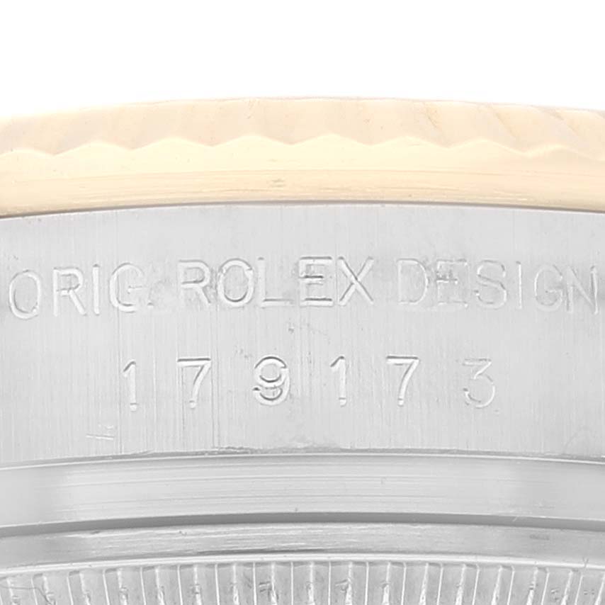 This close-up image shows the engraved side case of a Rolex Datejust 179173G Women's Steel and Gold (two tone) Champagne Dial 179173G Women's Steel and Gold (two tone) Champagne Dial model, with visible serial number and "Orig Rolex Design."