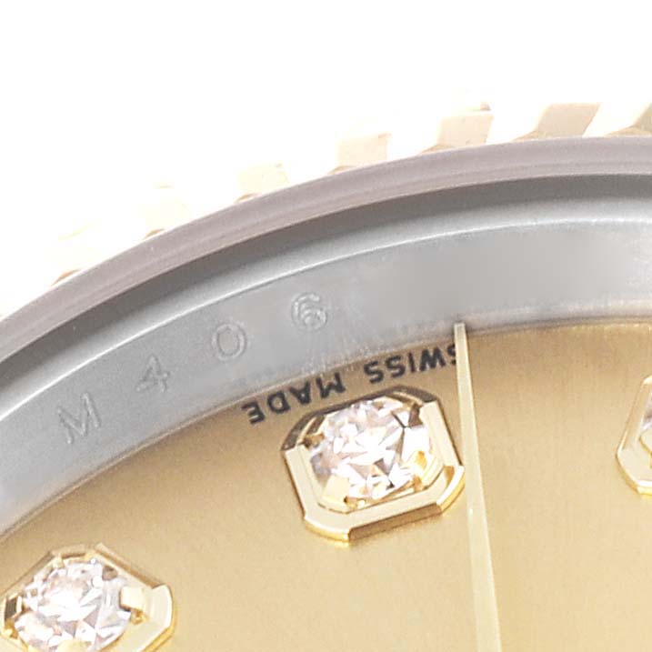 The image shows a close-up of the dial and bezel of a Rolex Datejust 179173G Women's Steel and Gold (two tone) Champagne Dial 179173G Women's Steel and Gold (two tone) Champagne Dial, highlighting the diamond markers and "Swiss Made" text.