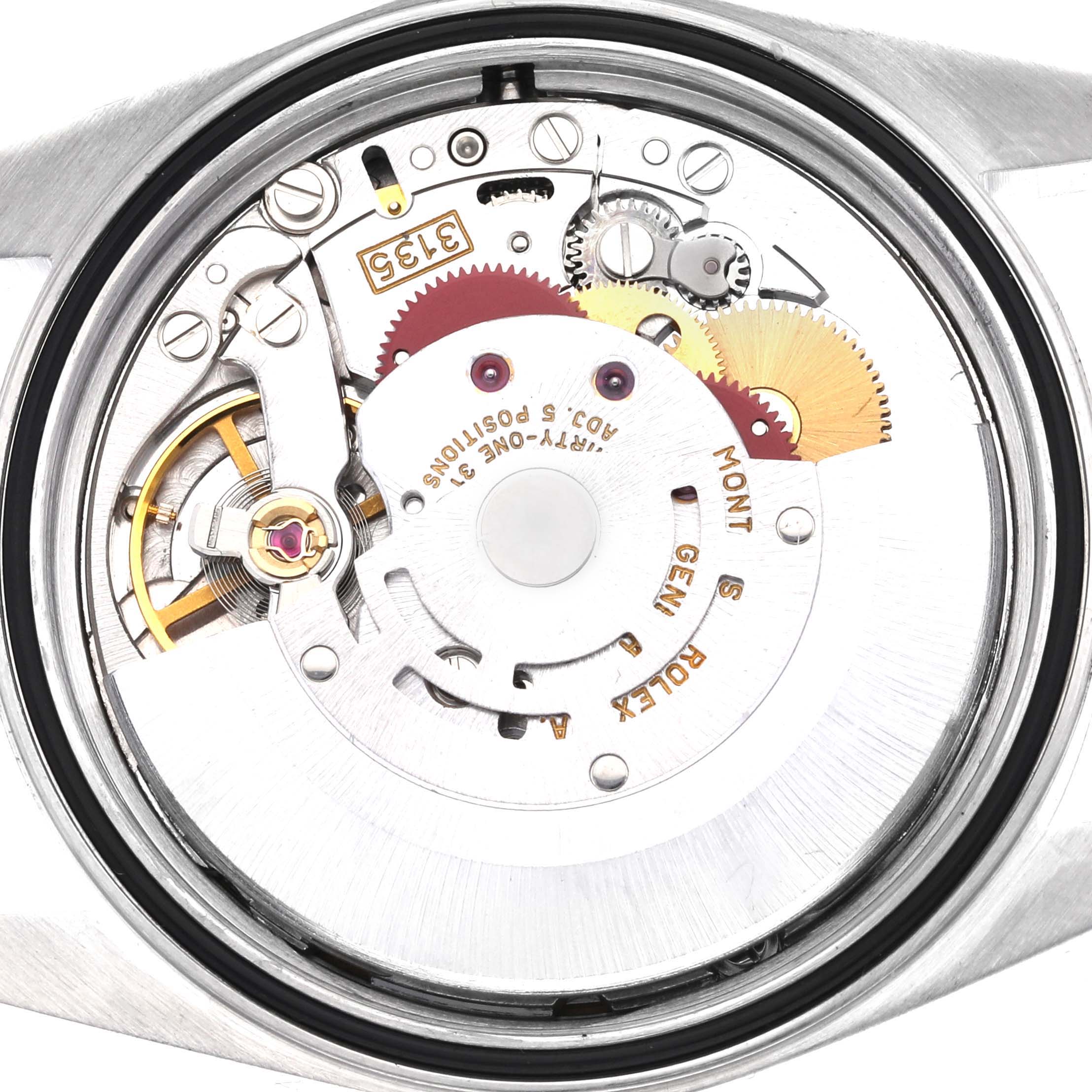 The image shows the back view of a Rolex Datejust 16233 Men
s Steel and Gold (two tone) Champagne Dial 16233 Men
s Steel and Gold (two tone) Champagne Dial watch, focusing on its intricate movement components.