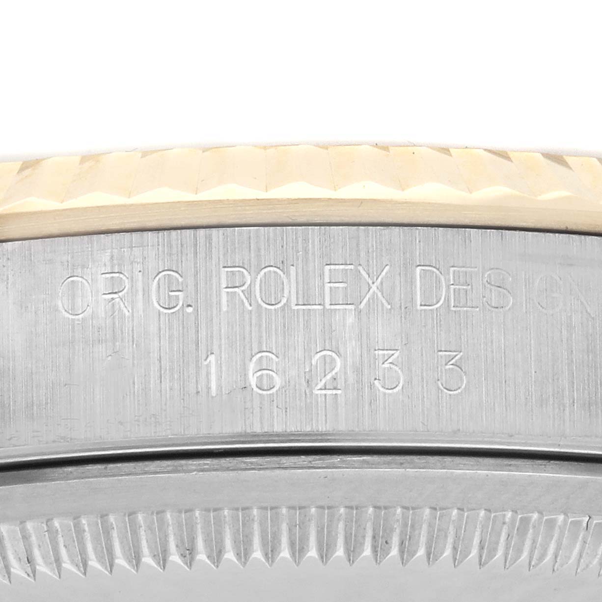 The image shows the engraved side of the Rolex Datejust 16233 Men
s Steel and Gold (two tone) Champagne Dial 16233 Men
s Steel and Gold (two tone) Champagne Dial
s case with model number "16233."