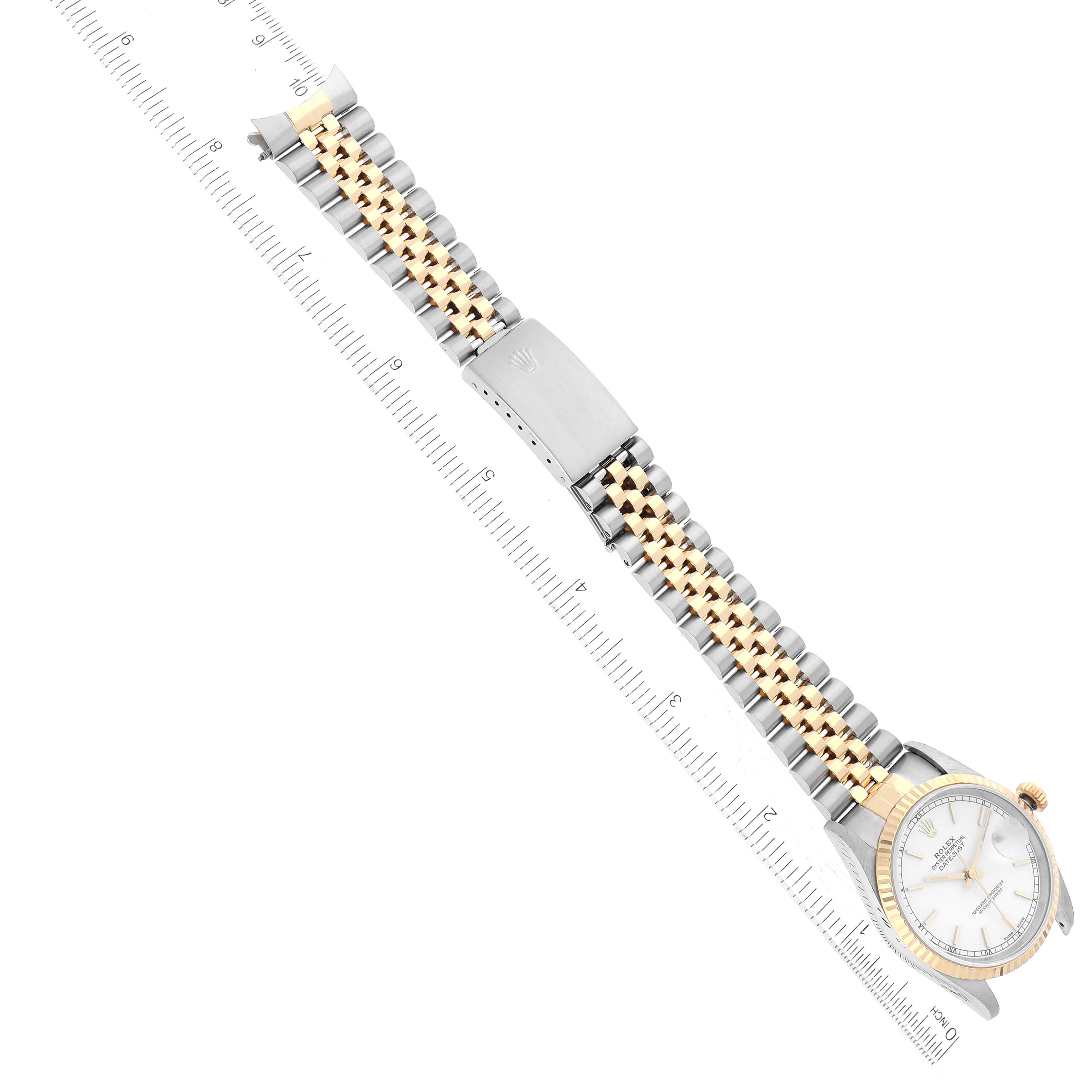 The image shows a top-down view of a Rolex Datejust 16233 Men's Steel and Gold (two tone) White Dial 16233 Men's Steel and Gold (two tone) White Dial watch with a ruler beside it.