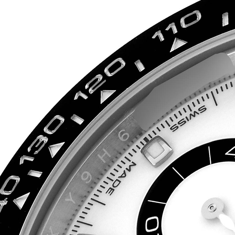 The image shows a close-up of the bezel and dial of the Rolex Daytona 116500LN Men's Stainless Steel White Dial 116500LN Men's Stainless Steel White Dial, highlighting the tachymetric scale.