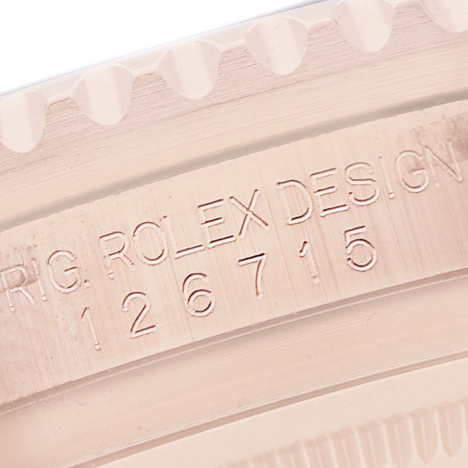 The image shows a close-up of the Rolex GMT-Master 126715 Men's Rose Gold Black Dial model's engraved inner bezel with the model number.