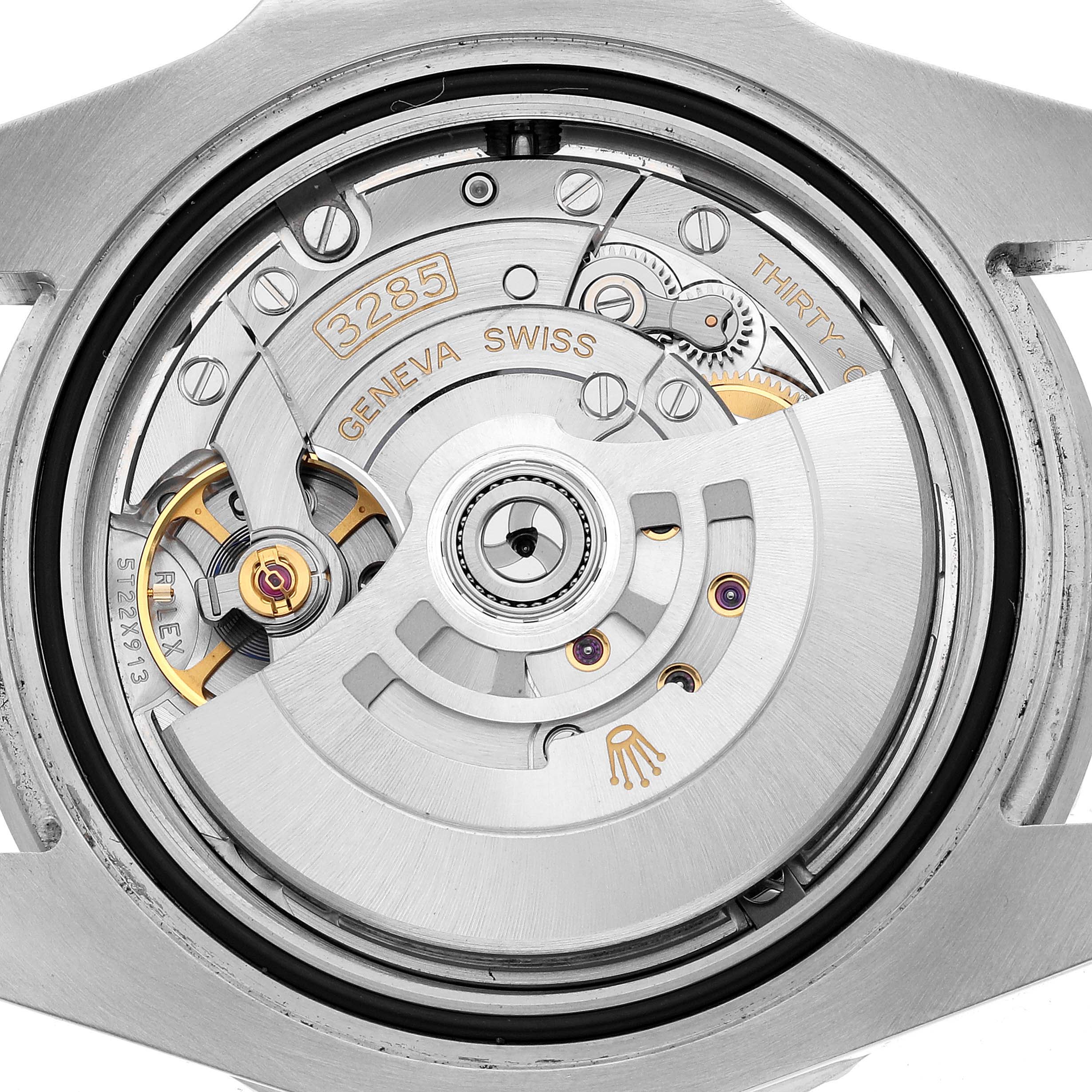 The image shows a close-up view of the movement inside a Rolex GMT-Master 126710 Men's Stainless Steel Black Dial watch, highlighting the rotor and internal mechanics.