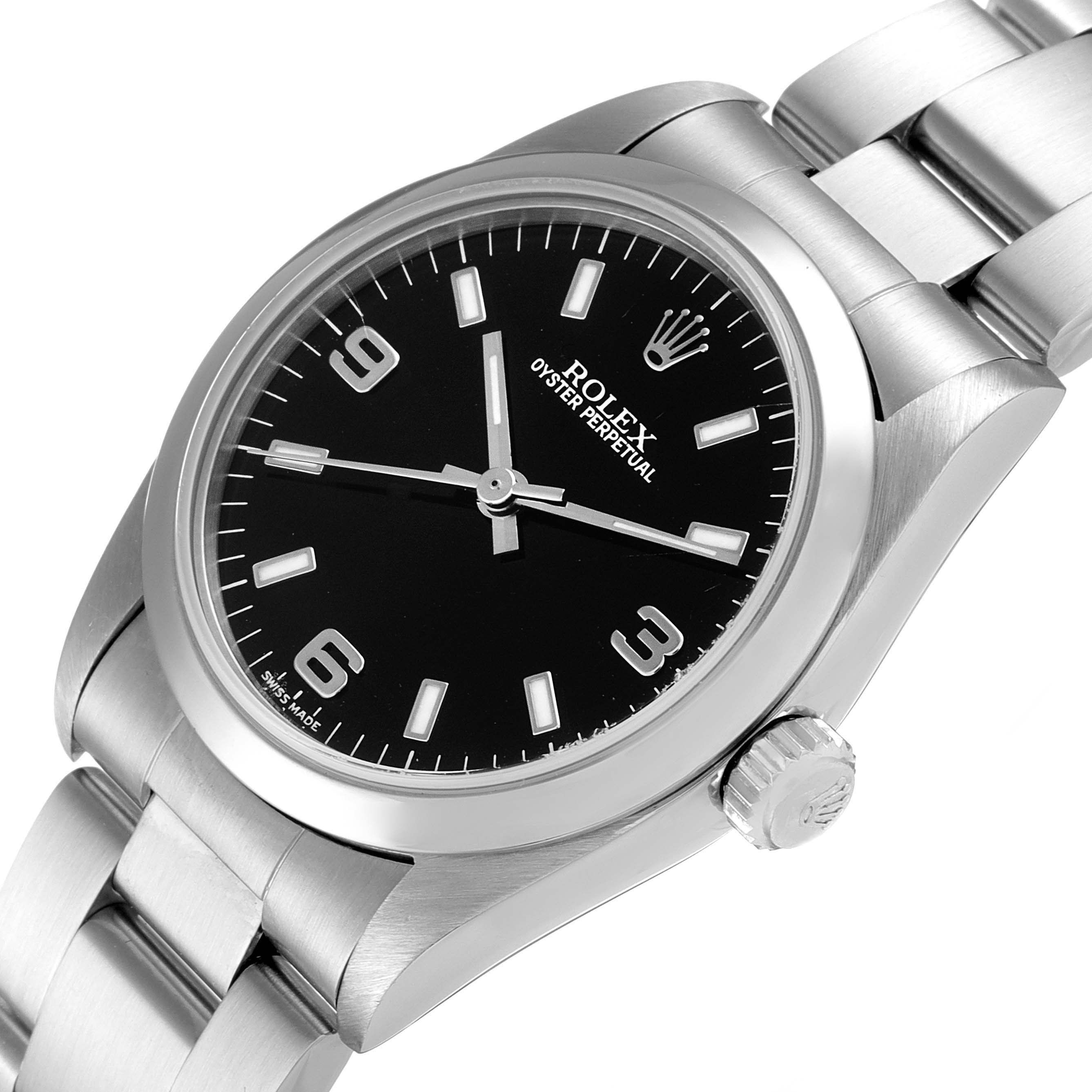 The image shows a Rolex Mid-Size 77080 Women's Stainless Steel Black Dial 77080 Women's Stainless Steel Black Dial Oyster Perpetual watch with a black dial, stainless steel case, and bracelet at a slight angle.