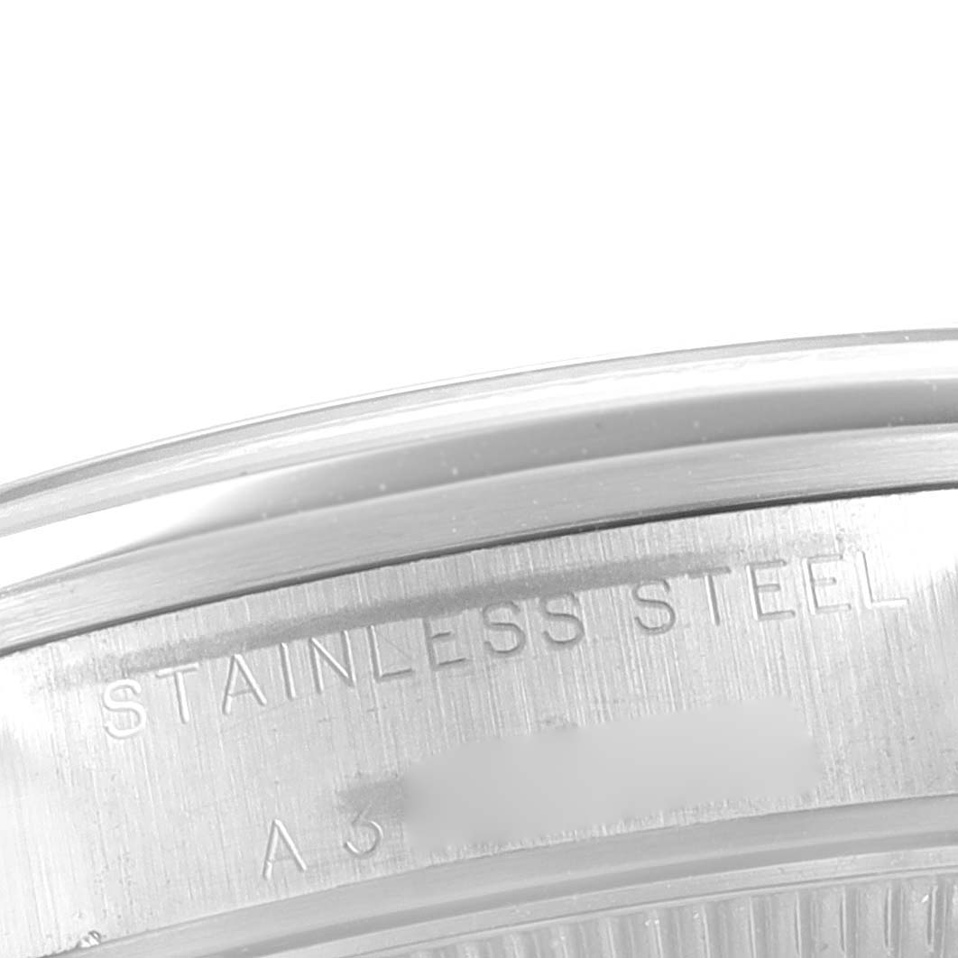 The image shows a close-up of the side of a stainless steel case back of a Rolex Mid-Size 77080 Women's Stainless Steel Black Dial 77080 Women's Stainless Steel Black Dial model watch.