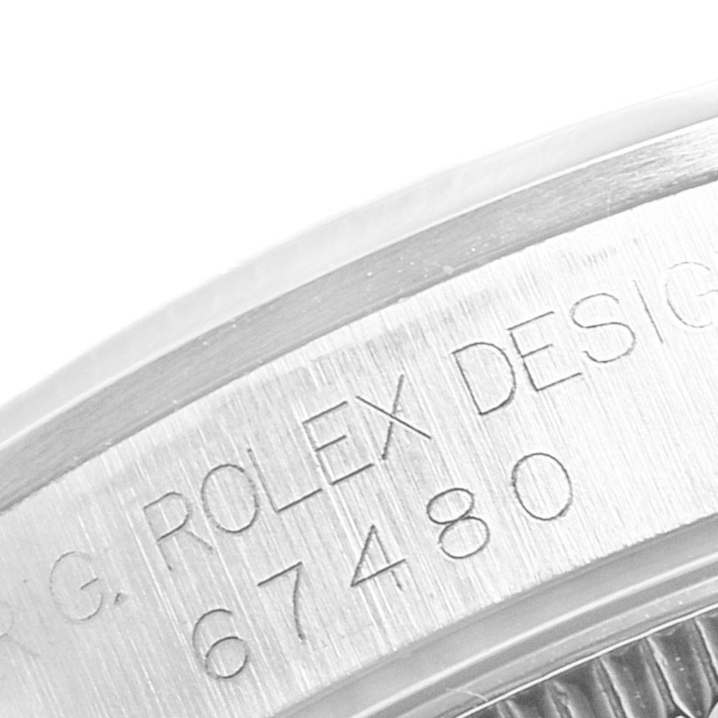 This image shows a close-up of the Rolex Mid-Size 67480 Women's Stainless Steel Black Dial 67480 Women's Stainless Steel Black Dial model's case engraving with the design number 67480.