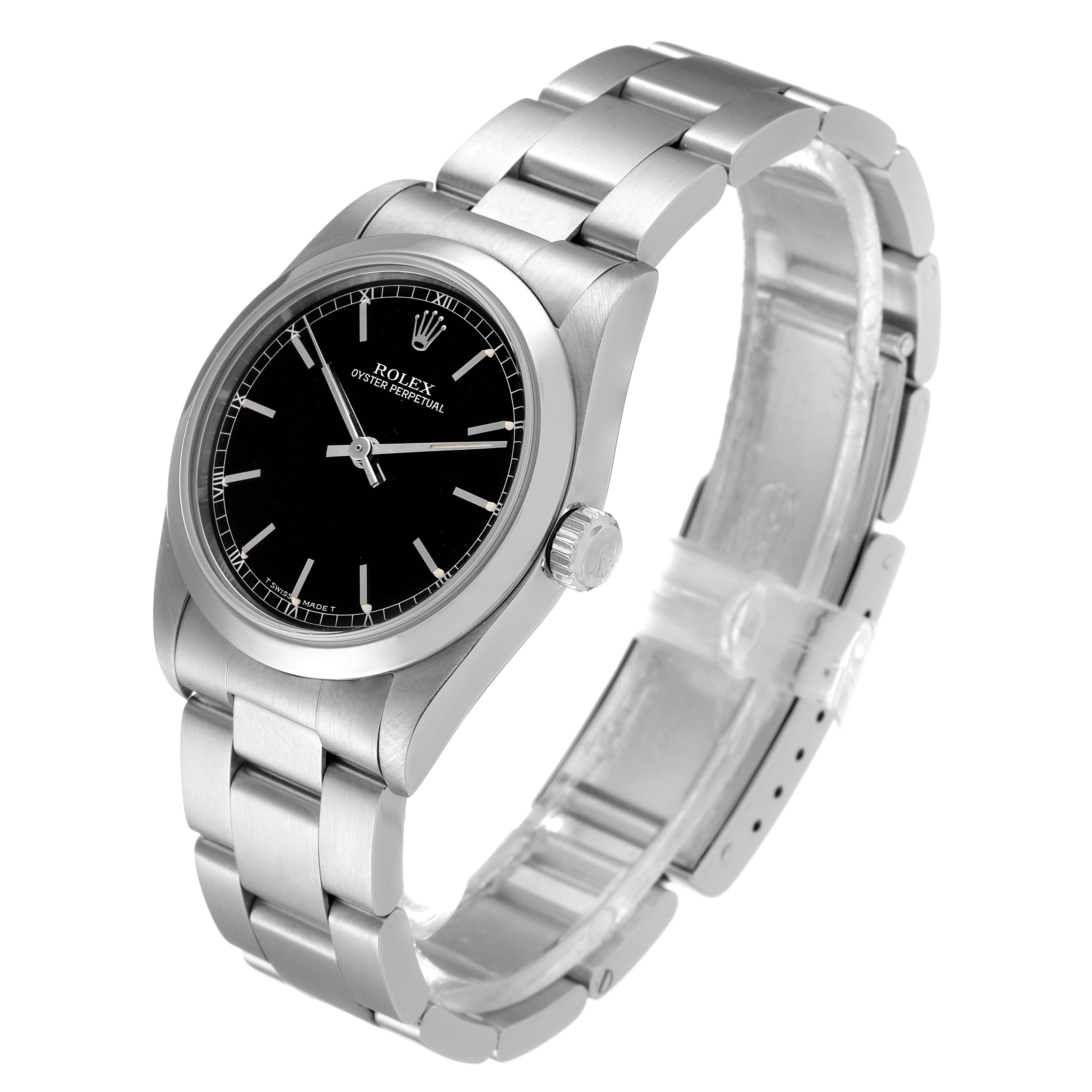 This Rolex Mid-Size 67480 Women's Stainless Steel Black Dial 67480 Women's Stainless Steel Black Dial Oyster Perpetual watch is shown from an angled side view, highlighting the face, case, crown, and bracelet.