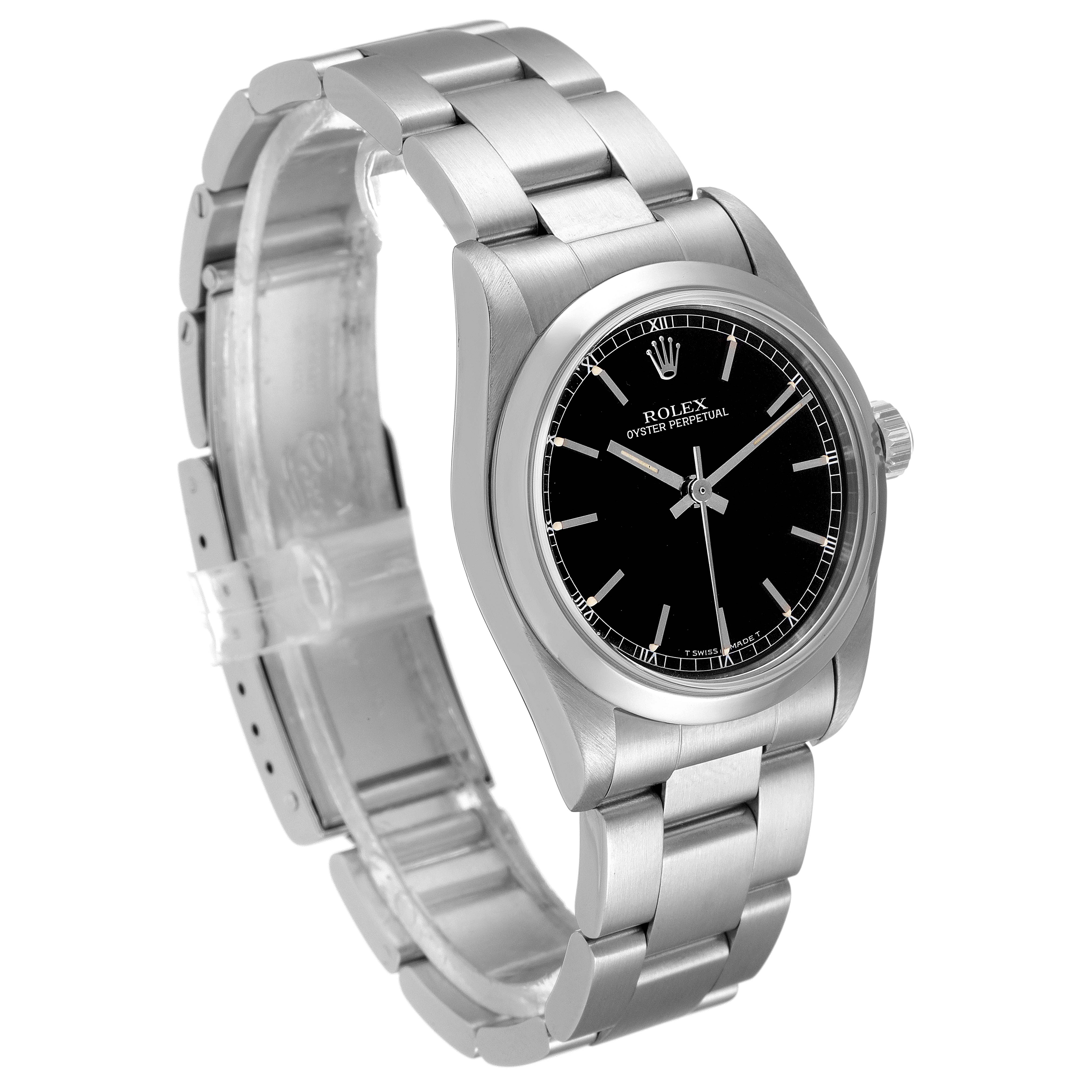 The image shows a side and slightly angled front view of a Mid-Size Rolex Oyster Perpetual watch, highlighting its black dial and bracelet.