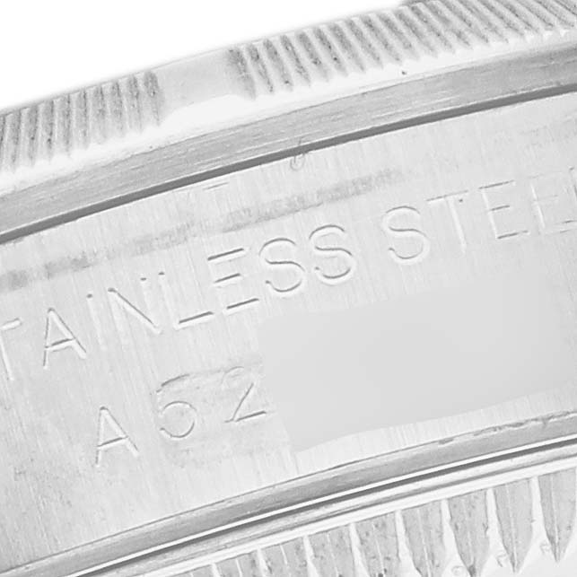 The image shows a close-up of the inner bezel of the Rolex Oyster Perpetual 76030 Women's Stainless Steel Pink Dial 76030 Women's Stainless Steel Pink Dial, highlighting its stainless steel material.