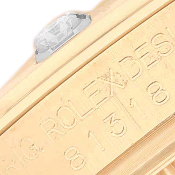 This image shows a close-up side view of a Rolex Pearlmaster 81318 Women's Yellow Gold Mother of Pearl Dial's bezel, highlighting a diamond and engraved details.