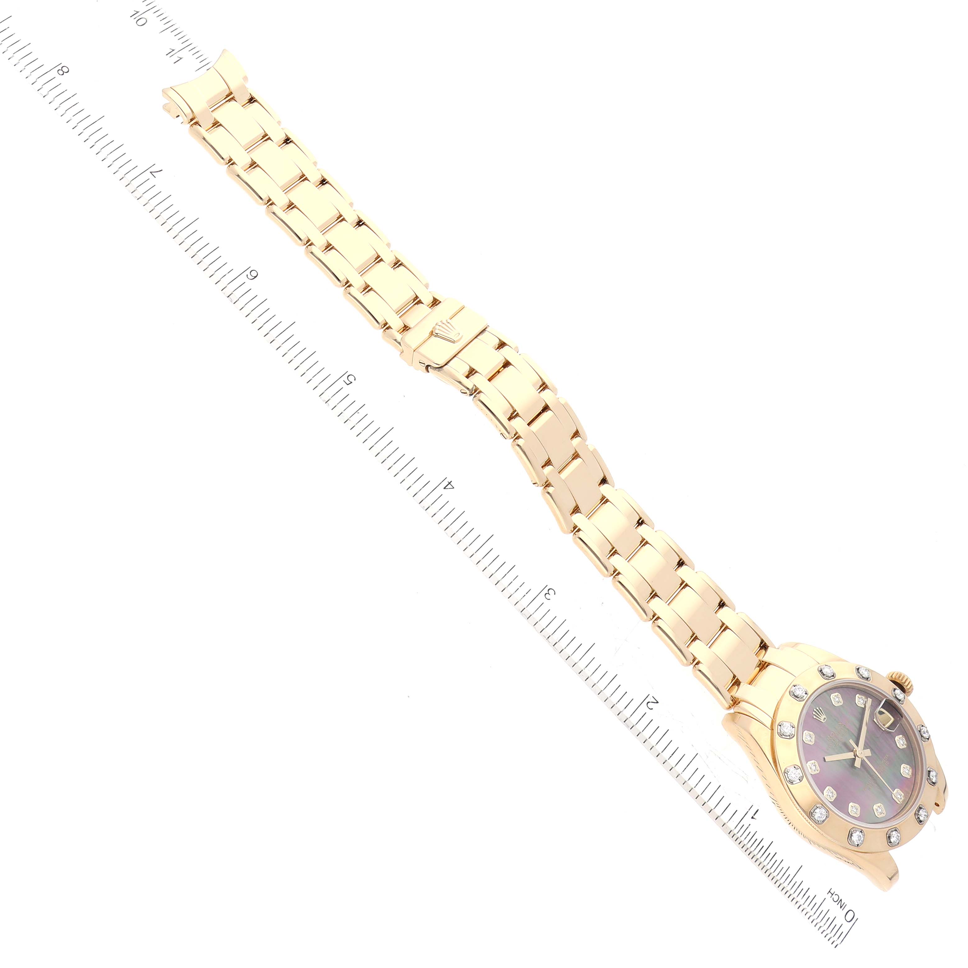 The image shows a Rolex Pearlmaster 81318 Women's Yellow Gold Mother of Pearl Dial 81318 Women's Yellow Gold Mother of Pearl Dial watch laid flat with the full bracelet and face visible, next to a ruler for scale.