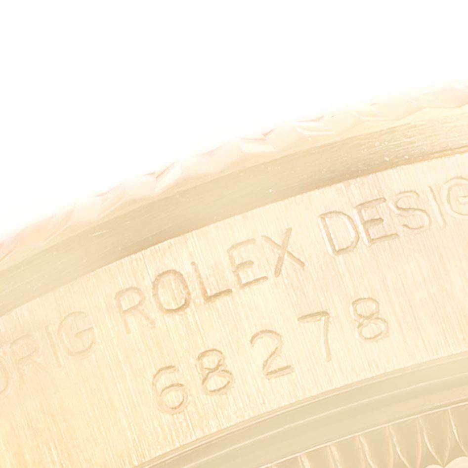 This image shows an extreme close-up of the engraving on the case side of a Rolex President 38706 Women
s Yellow Gold Champagne Dial 38706 Women
s Yellow Gold Champagne Dial model watch.