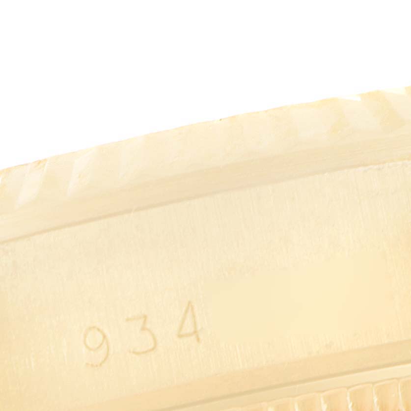 This close-up image shows the edge of the bezel and part of the casing for the President model by Rolex, featuring the number "934."