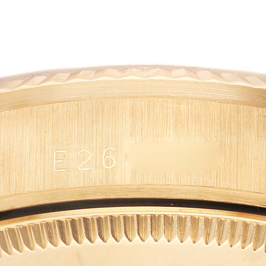 This close-up image shows the serial number engraving on the side of the Rolex President 68278 Women's Yellow Gold Black Dial 68278 Women's Yellow Gold Black Dial model watch case.