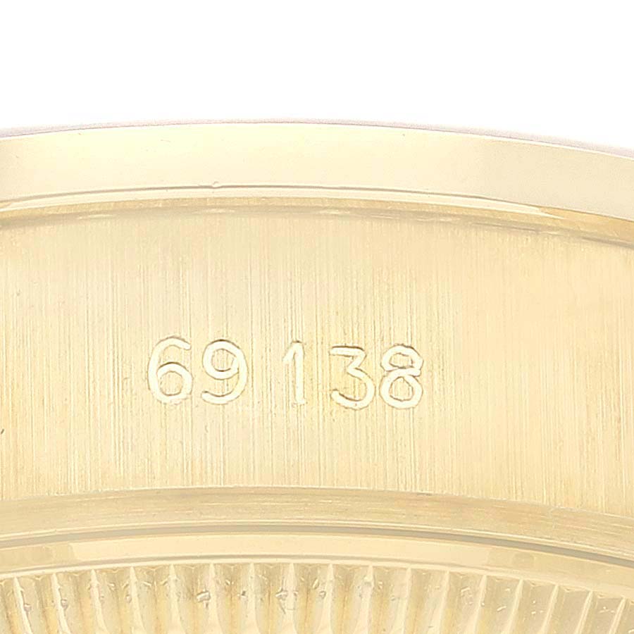 This close-up image shows the model number "69138" engraved on the gold case of a Rolex President 69138G Women
s Yellow Gold Champagne Dial 69138G Women
s Yellow Gold Champagne Dial watch.