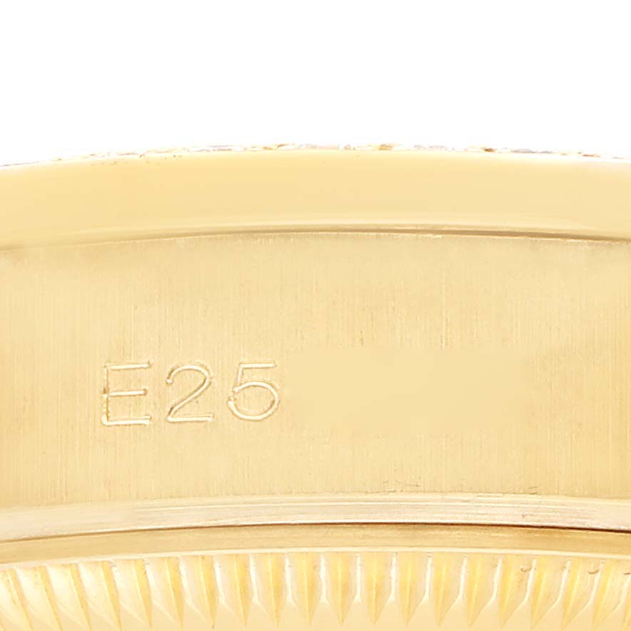 The image shows a close-up of the side of a Rolex President 69158 Women's Yellow Gold Champagne Dial watch, displaying its engraved markings and part of the fluted bezel.