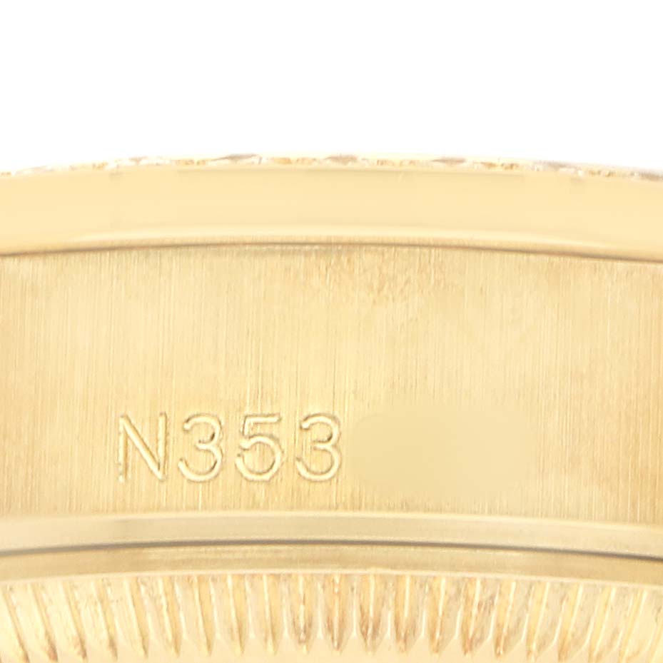 The image shows a close-up of the gold bezel edge and a serial number of a Rolex President 69158 Women's Yellow Gold Champagne Dial model.