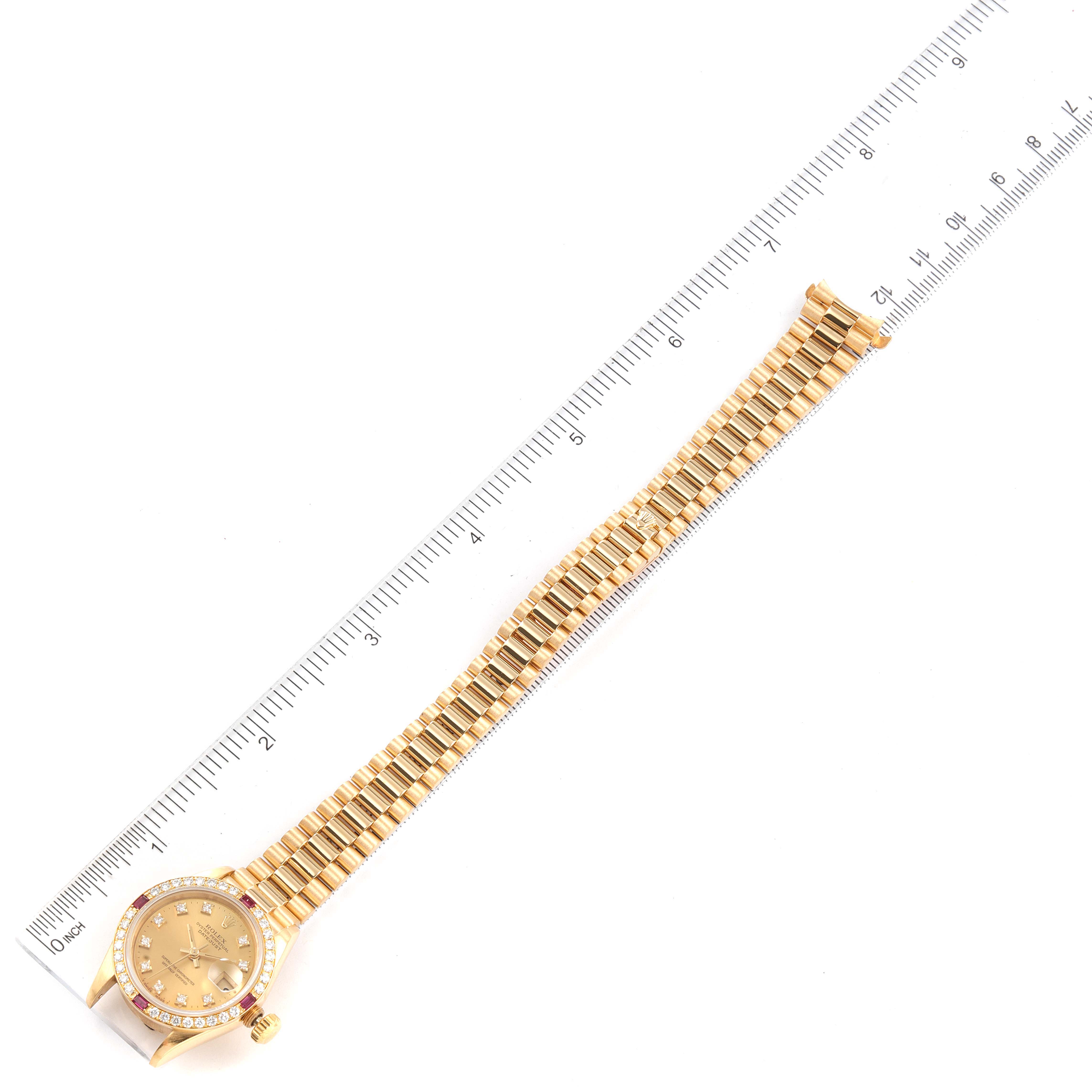 The image shows a top-down view of a Rolex President 69068 Women
s Yellow Gold Champagne Dial 69068 Women
s Yellow Gold Champagne Dial model watch alongside a ruler for scale.