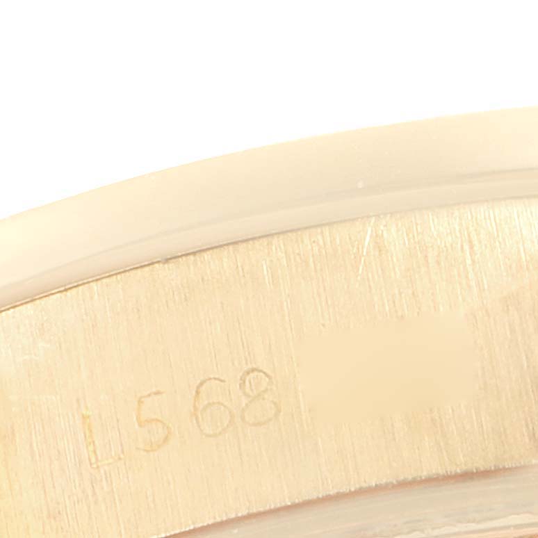 This is a close-up shot of the case back engraving and the serial number of a Rolex President 69068 Women
s Yellow Gold Champagne Dial 69068 Women
s Yellow Gold Champagne Dial model watch.