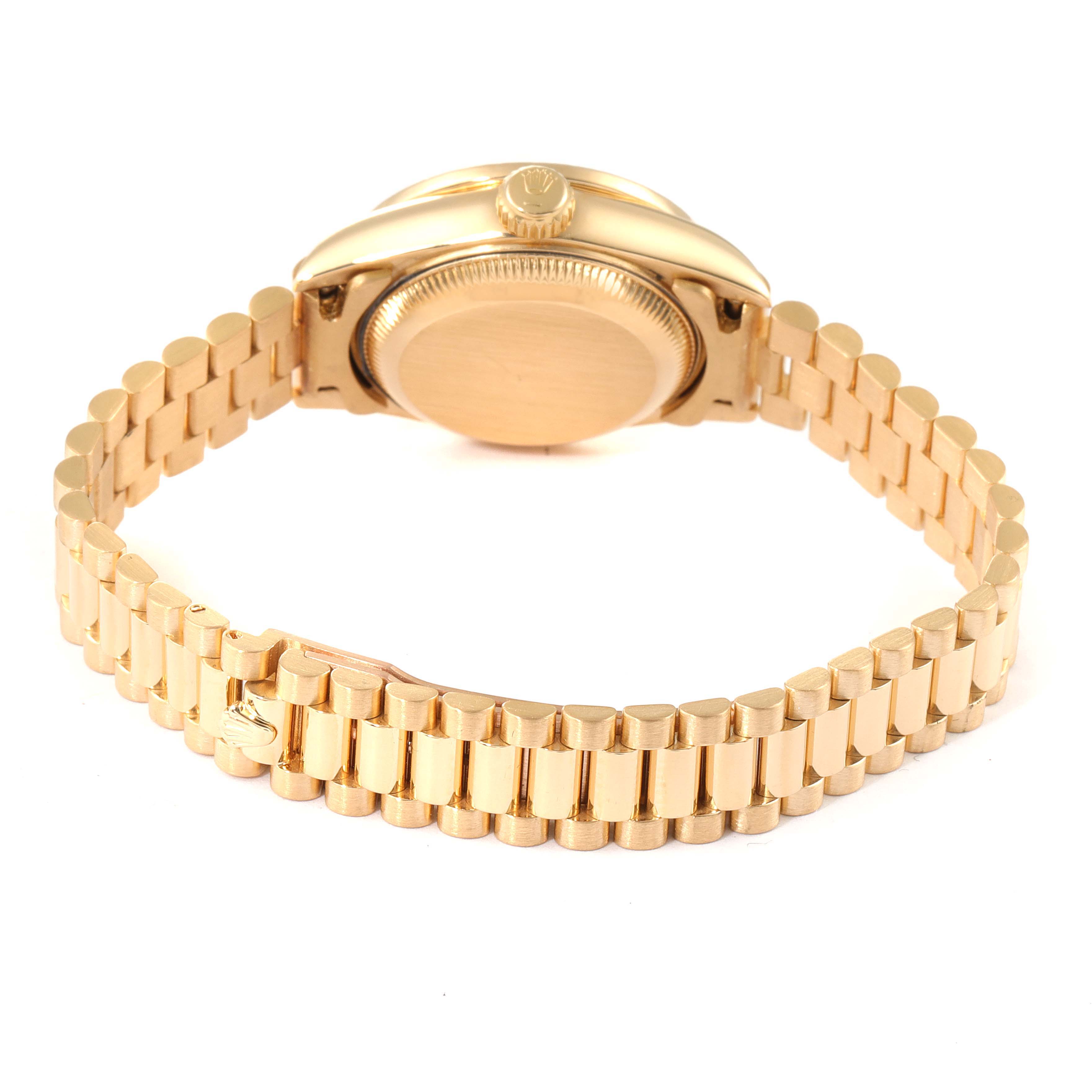 The image shows the back view of the Rolex President 69068 Women
s Yellow Gold Champagne Dial 69068 Women
s Yellow Gold Champagne Dial model watch, focusing on its golden bracelet and caseback.