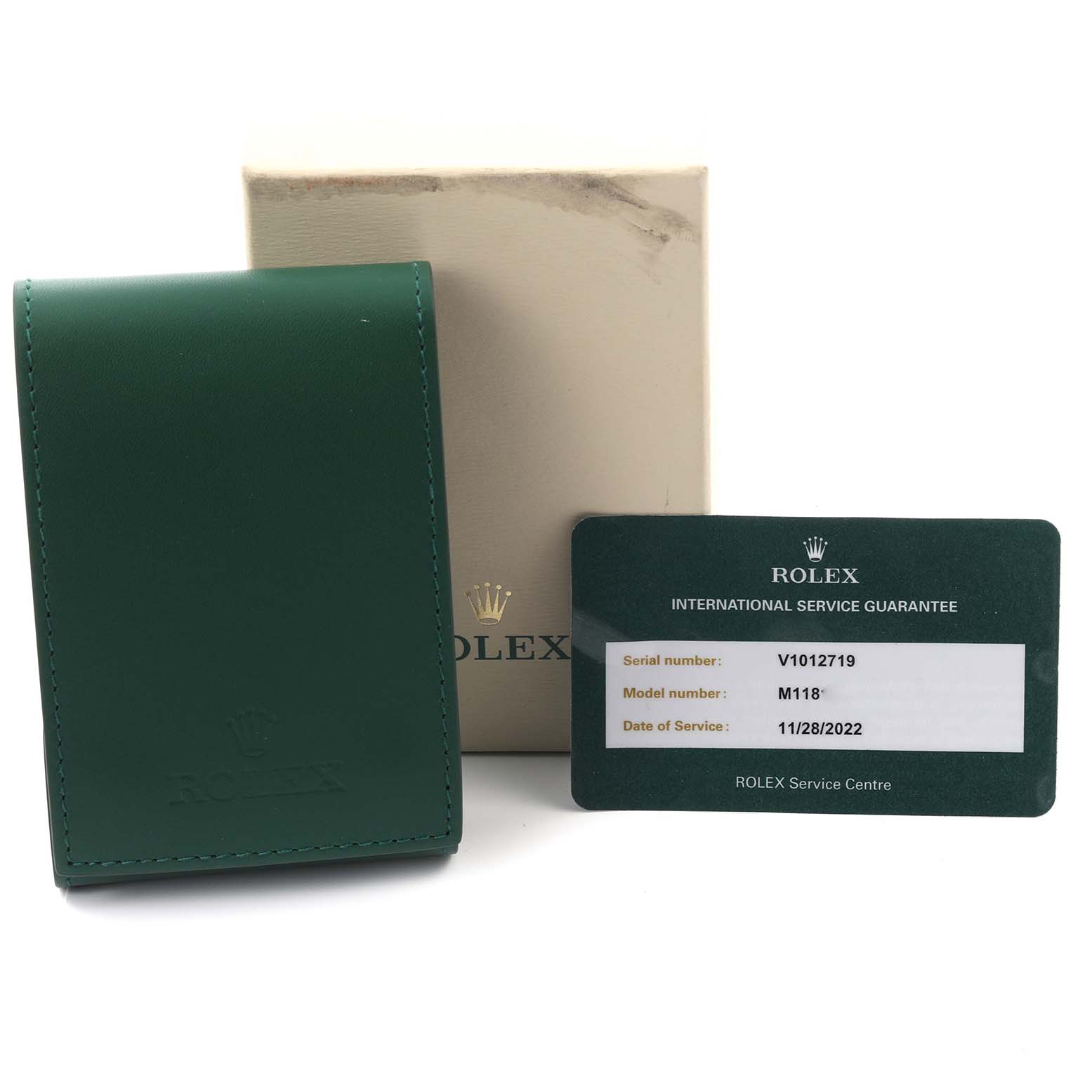 The image shows a Rolex President 118135 Men
s Rose Gold Brown Dial 118135 Men
s Rose Gold Brown Dial model box, green leather pouch, and service guarantee card.