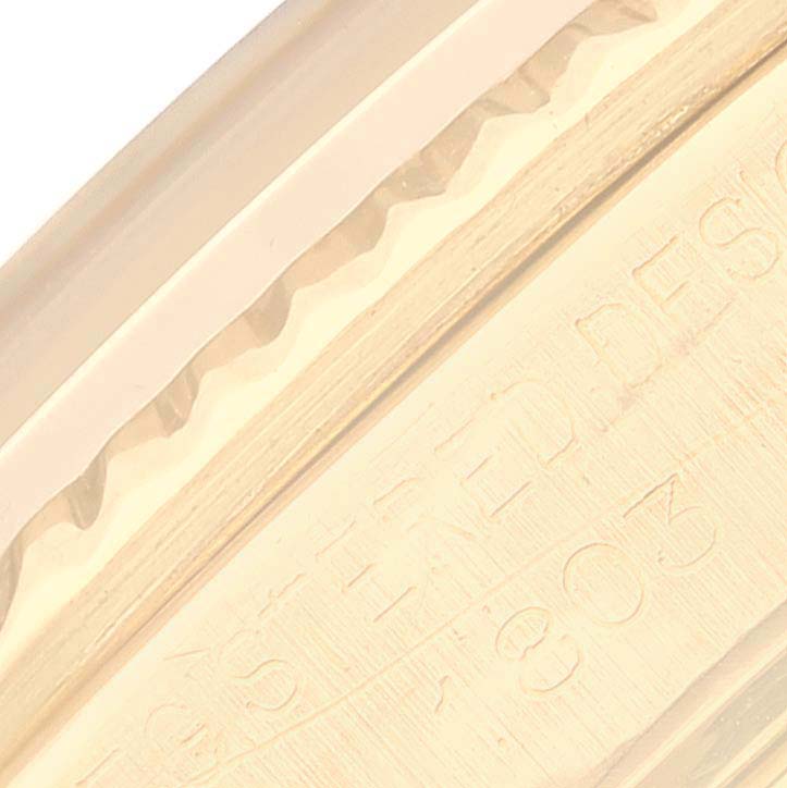 The image shows a close-up angle of the side of the Rolex Vintage Collection 1803 Men's Yellow Gold Silver Dial 1803 Men's Yellow Gold Silver Dial model, highlighting the engraved details.