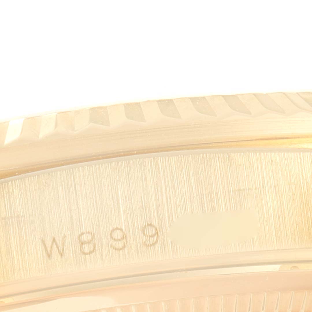 This image shows a close-up of the engraved case rim of a Rolex President 18238 Men's Yellow Gold Brown Dial 18238 Men's Yellow Gold Brown Dial model watch.