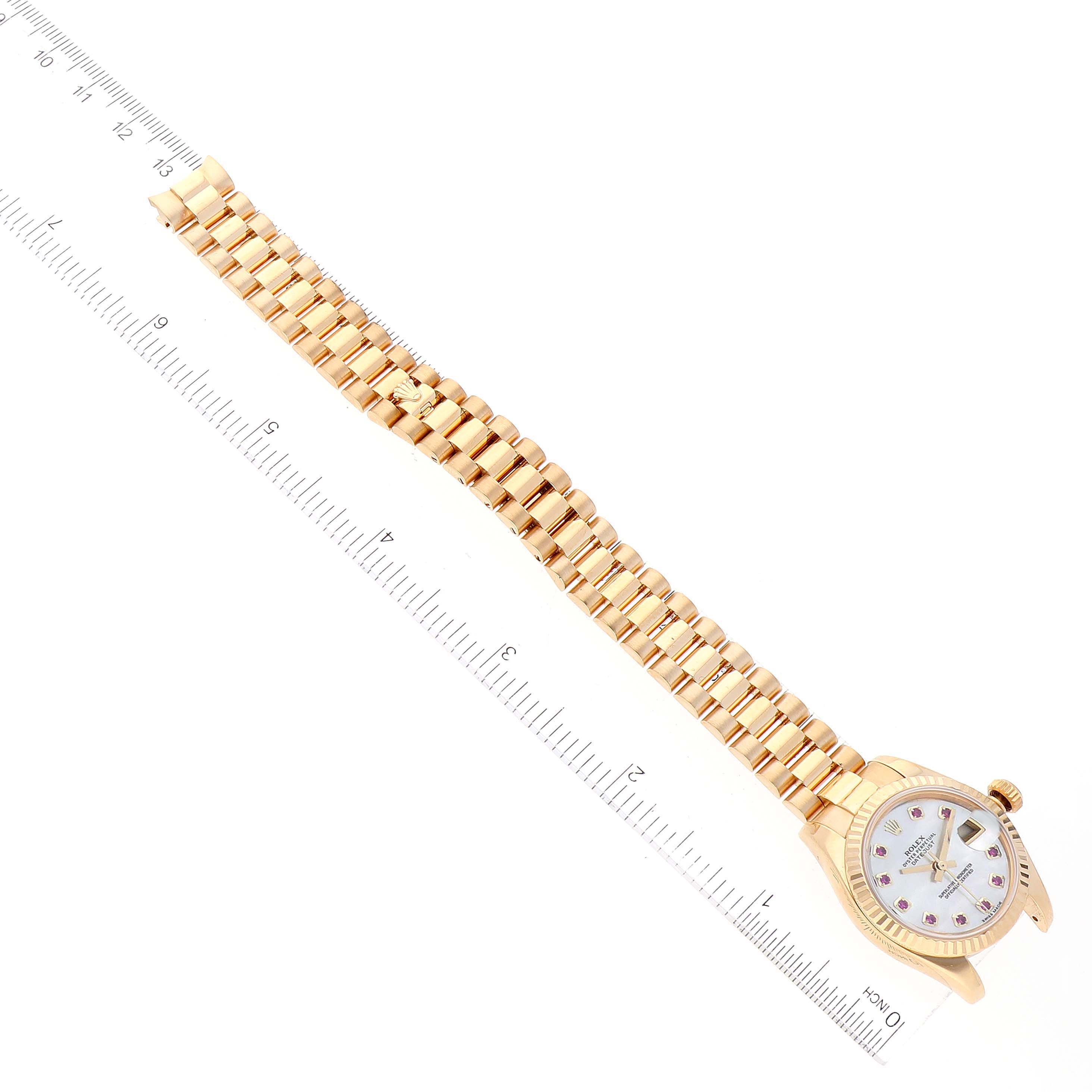 The image shows a Rolex President 179178 Women's Yellow Gold Mother of Pearl Dial 179178 Women's Yellow Gold Mother of Pearl Dial watch laid flat with its gold bracelet and dial visible, alongside a measuring ruler.