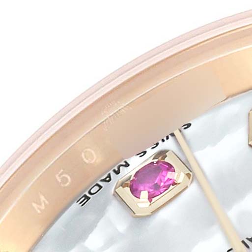 This close-up of the Rolex President 179178 Women's Yellow Gold Mother of Pearl Dial 179178 Women's Yellow Gold Mother of Pearl Dial watch showcases part of its face, bezel, and a ruby hour marker.