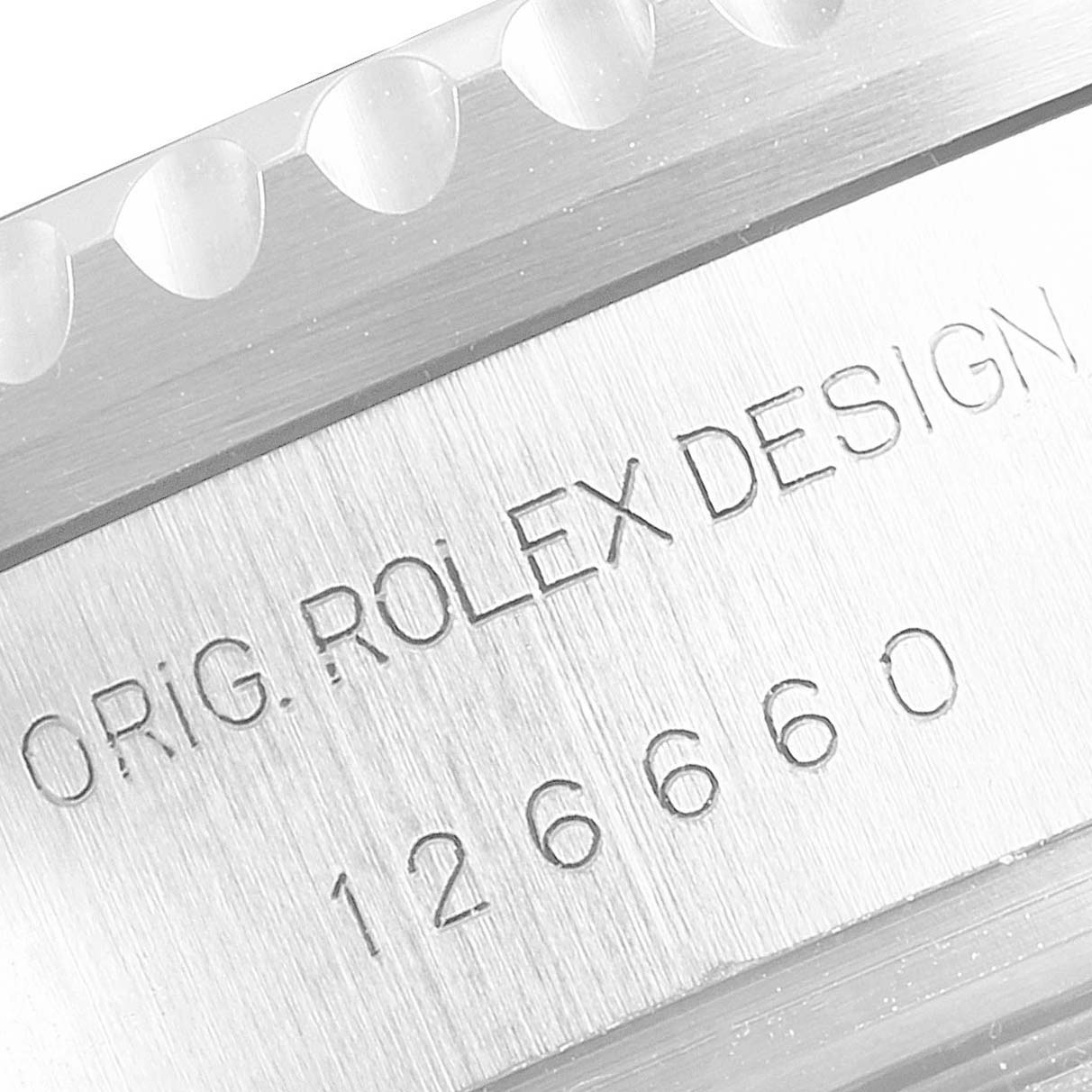 The image shows a close-up of the Rolex Sea-Dweller 126660 Men's Stainless Steel Blue Dial 126660 Men's Stainless Steel Blue Dial model's engraved design and model number, highlighting the manufacturer's details.