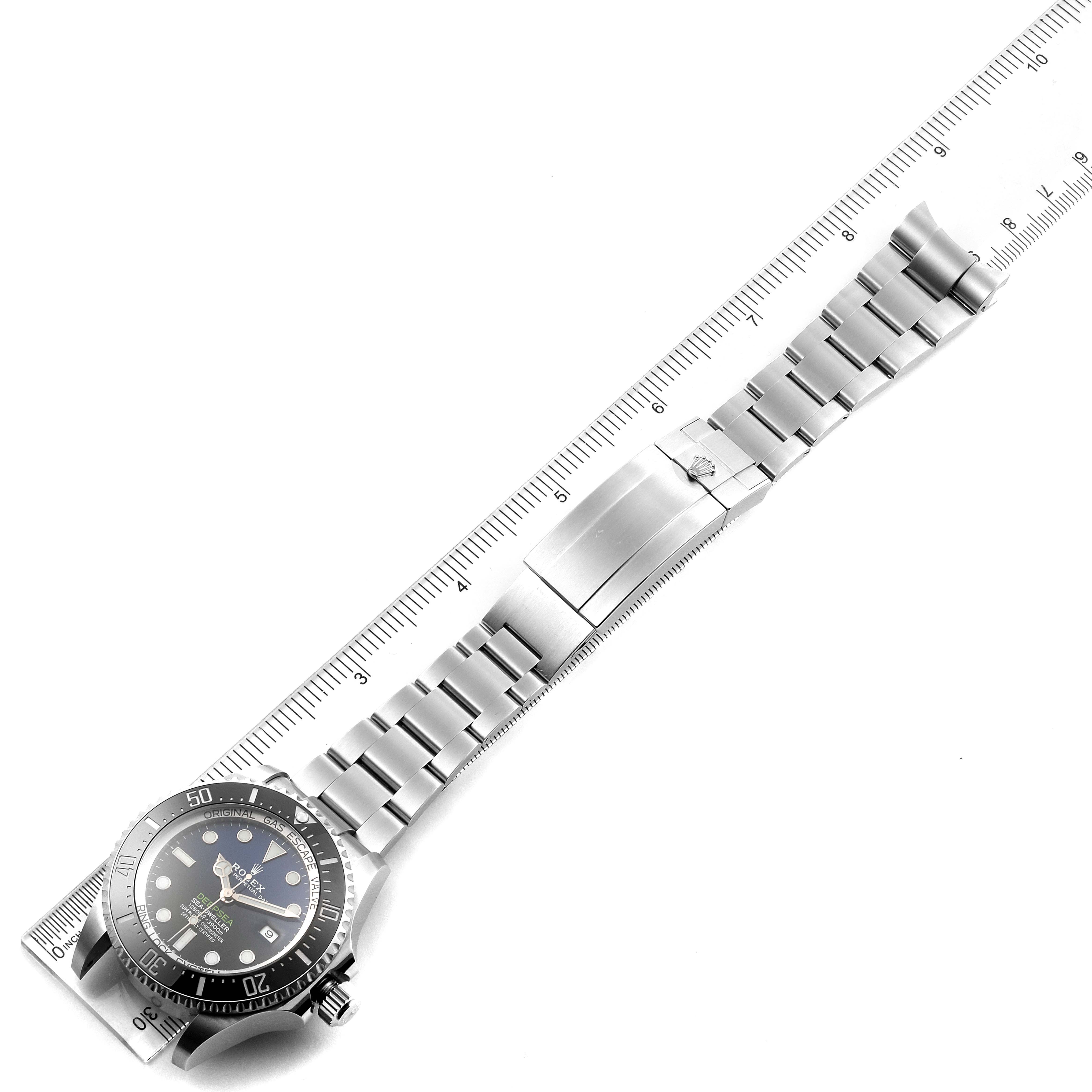 The image shows a top-down view of a Rolex Sea-Dweller 126660 Men's Stainless Steel Blue Dial 126660 Men's Stainless Steel Blue Dial watch, its band, and clasp next to a ruler for scale.