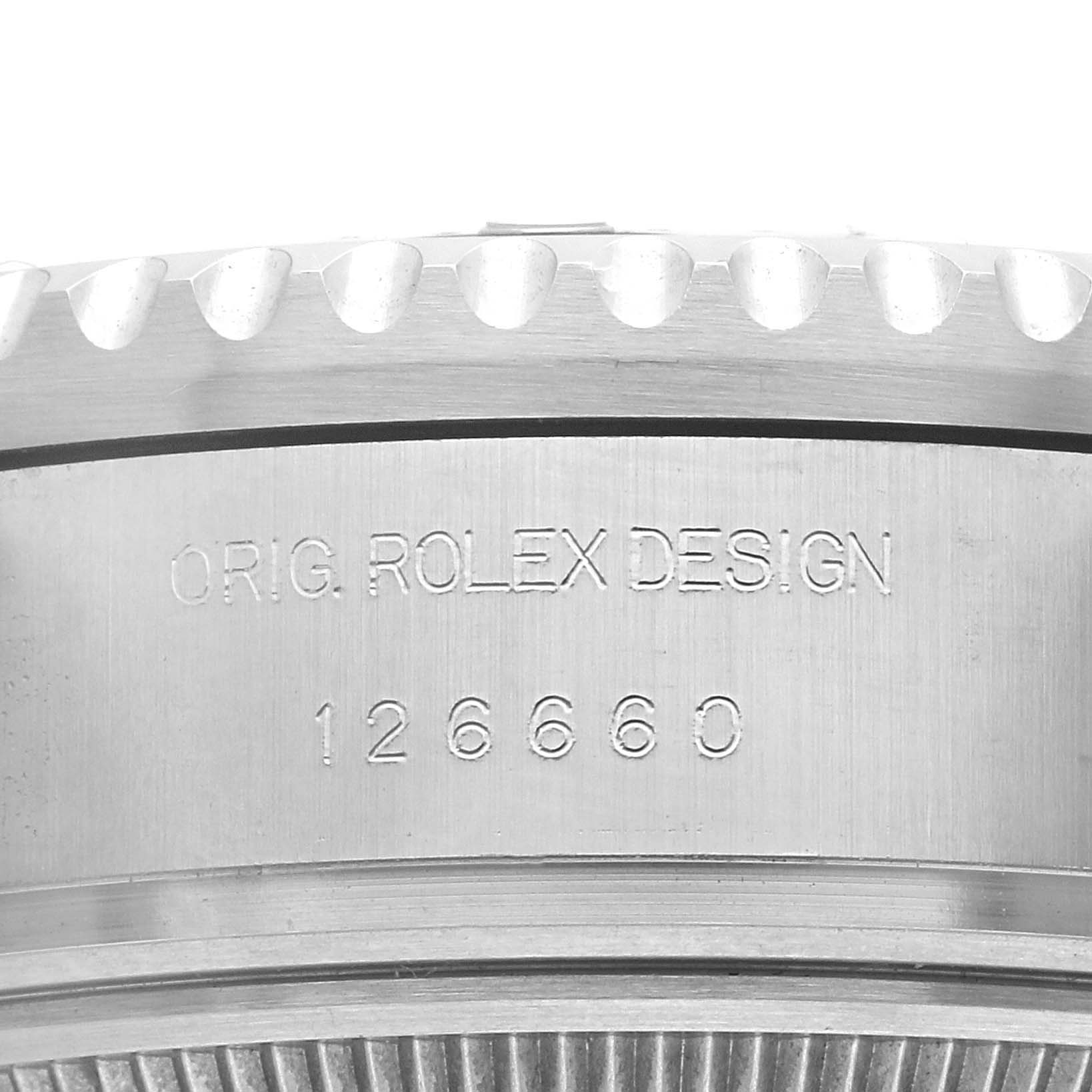 The image shows a close-up of the edge of the Rolex Sea-Dweller 126660 Men's Stainless Steel Black Dial's bezel, displaying the model number and design engraving.