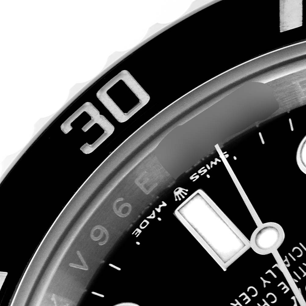 This image shows a close-up of the bezel and part of the dial of a Rolex Submariner 126610LN Men
s Stainless Steel Black Dial 126610LN Men
s Stainless Steel Black Dial, focusing on the 30-minute mark.