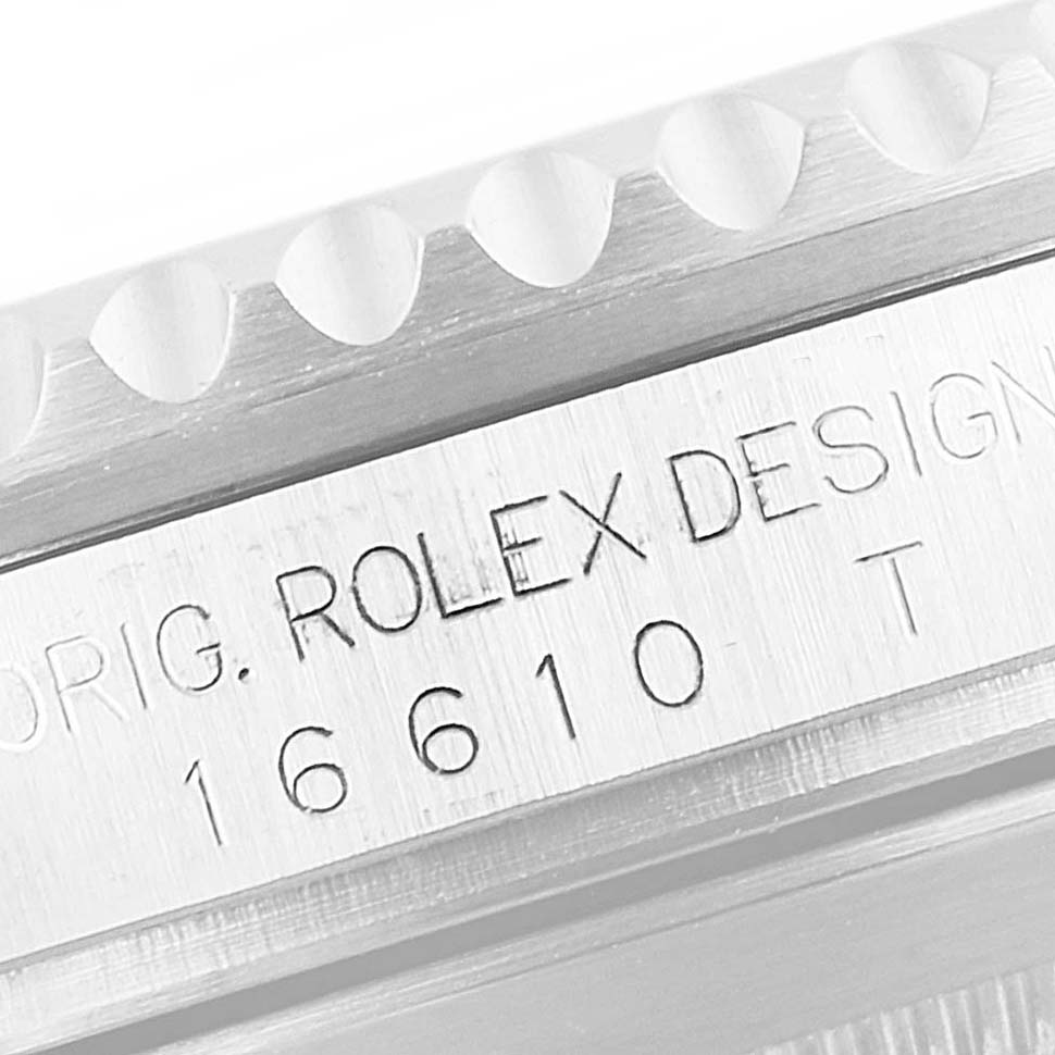 The image shows a close-up of the bezel and case side of a Rolex Submariner 16610LV Men
s Stainless Steel Black Dial 16610LV Men
s Stainless Steel Black Dial, specifically displaying its model number and "Rolex Design" engraving.