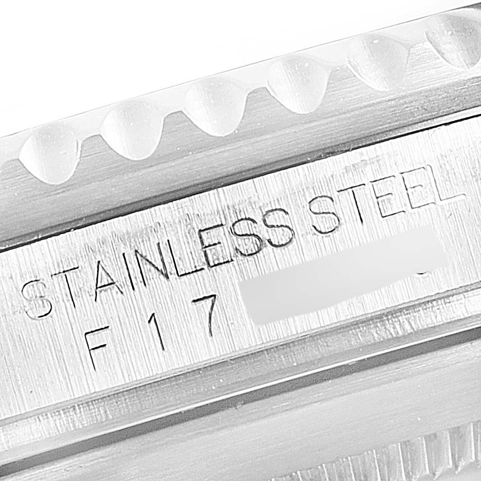 This image shows a close-up of the case side engraving ("STAINLESS STEEL") and part of the bezel of a Rolex Submariner 16610LV Men
s Stainless Steel Black Dial 16610LV Men
s Stainless Steel Black Dial watch.