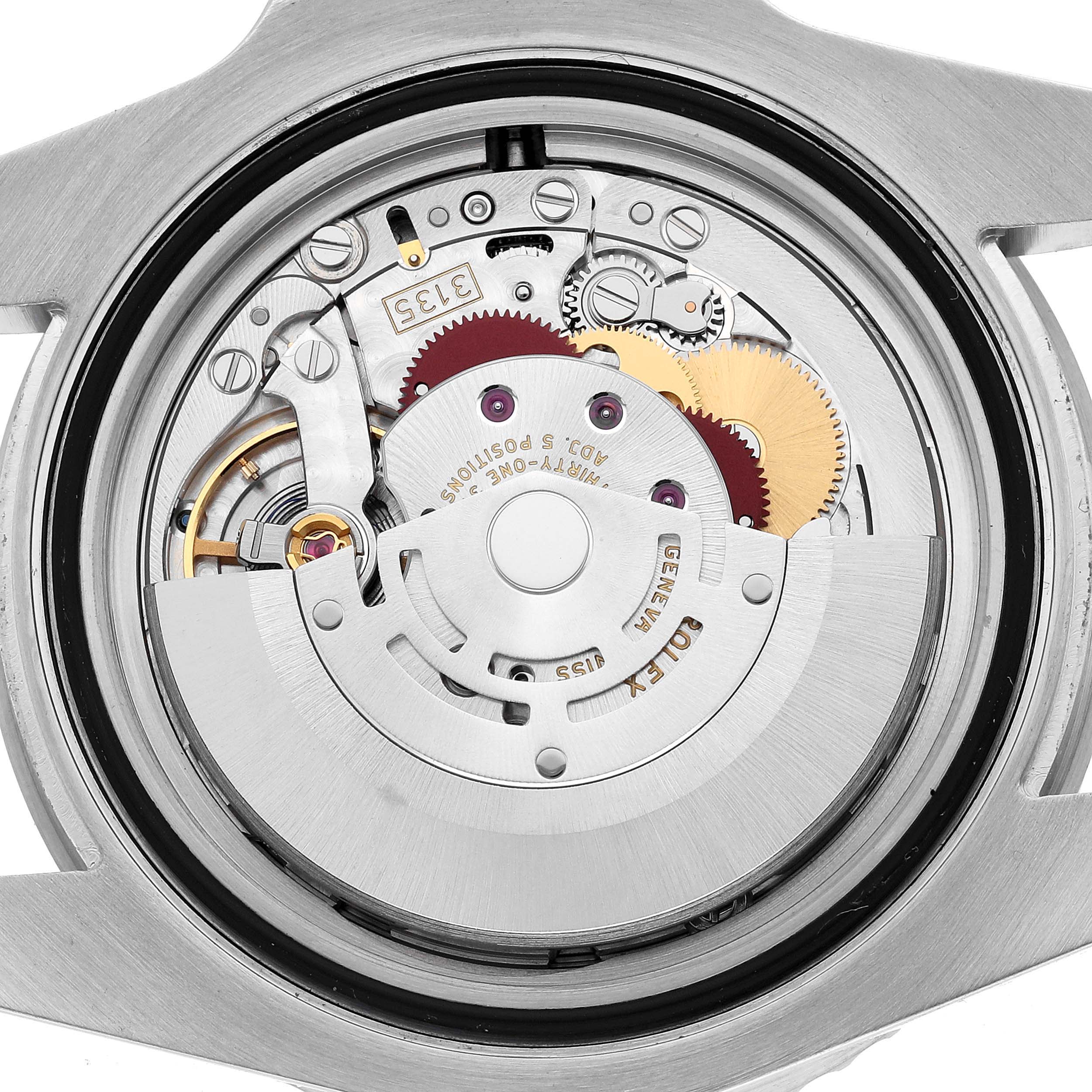 The image shows the back view of a Rolex Submariner 116610LV Men's Stainless Steel Green Dial, revealing its intricate movement and internal components.