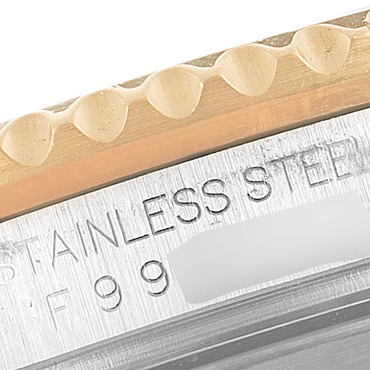 This close-up shot shows the engraved stainless steel and a portion of the bezel on a Rolex Submariner 16613 Men's Steel and Gold (two tone) Grey Dial 16613 Men's Steel and Gold (two tone) Grey Dial.