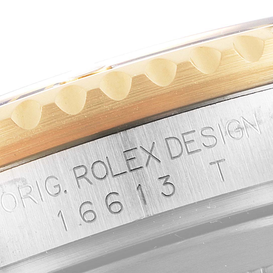 This image shows a close-up angle of the serial number and the bezel edge of a Rolex Submariner 16613 Men's Steel and Gold (two tone) Champagne Dial 16613 Men's Steel and Gold (two tone) Champagne Dial.